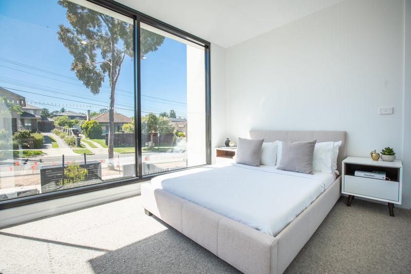 Minimal bedroom with soft finishes and generous natural light.