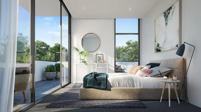 Sunlit bedroom opening to a terrace with large sliding doors and smooth plasterboard walls.